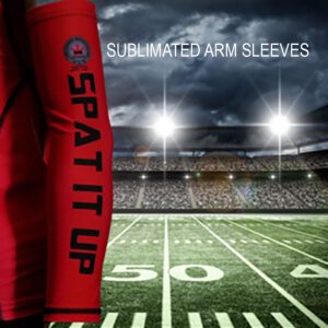 A red arm sleeve on top of an empty football field.